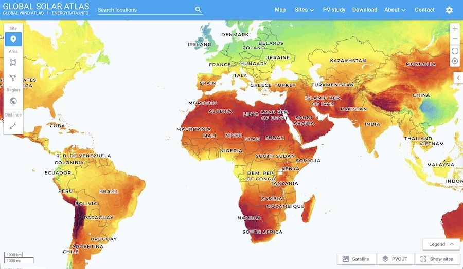 Screenshot of the Global Solar Atlas web tool showing a world map coloured by long-term PV yield — deep reds across the desert belts of the Sahara, Arabia, Australian Outback and Atacama; greens and yellows across mid-latitudes.
